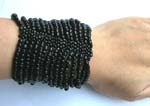 Black rainbow seed beaded bracelet forming in wide band design 