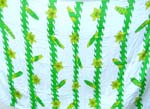 White batik sarong wrap motif flowers and leafs hanging on green wavy line design 