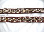 Seashell forming in flower pattern in red color belt with two strings for closure