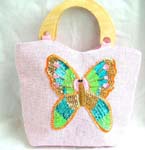 Pink canvas fabric with sequins wooden handle handbag motif butterfly feature in sparkle chips and thread work design with zipper closure and inner zipper pocket 