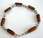 Tiger's eye fashion bracelet in long shape connected with silver heart design and chain lock for closure 