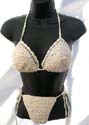 Slide sequined beige halter bikini top matched with bow tie thong. Tie on neck and in back