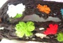 Black crochet needle work scarf with mini rainbow floral along and fringes end design