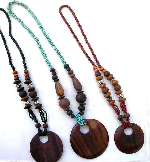 Wooden pendant dangling from beaded necklace, fashion express boutique