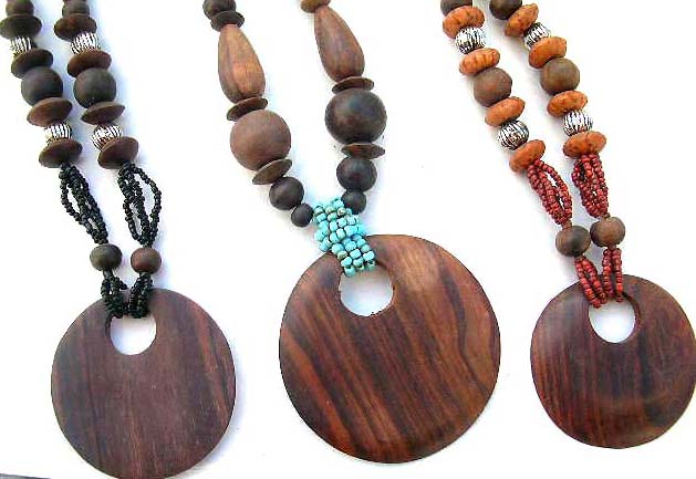 Wooden pendant dangling from beaded necklace, fashion express boutique