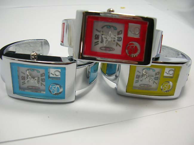 Silver bangle watch with rainbow colored enamel on clock face, jewelry manufacturing dealer