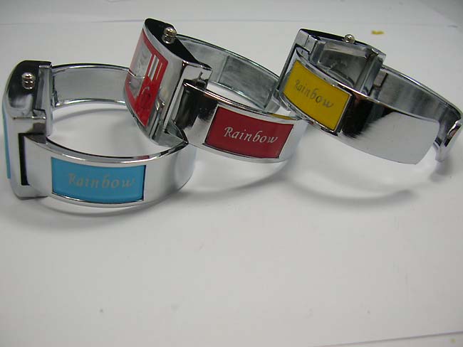 Silver bangle watch with rainbow colored enamel on clock face, jewelry manufacturing dealer