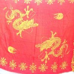 fashion trend. organge red sarong wrapped skirts with Chinese dragons play with flaming pearls.