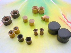 Wooden Saddles Plugs Tunnel Earlets small to large gauge mix. Wooden plugs and ear stretchers and expanders