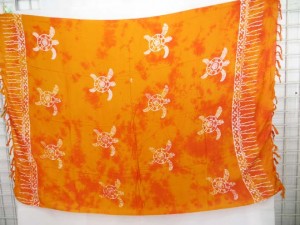 monocolor orange sarong screen printings with leaves, sun, dolphin, seashell, palm leaves etc tropical designs