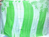 green white sarong with flowers on two corners 