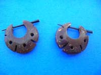 Carved hole and line designs in wooden earrings