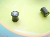 Flashing light earplug earring. Organic plugs made from buffalo horn