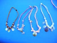 Opal colored seashells on multi string necklace with beaded spiral at base 