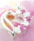3 pink and 4 clear cz gems inlaid on one side of Sterling silver pendant charm