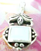 Ornate sterling silver necklace charm with mother of pearl seashell
