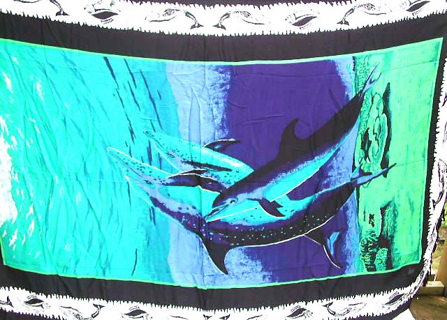 Four dolphin playing in the green and blue deep sea 