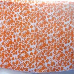 Sarong wholesaler. garden floral orange sarong on white background.